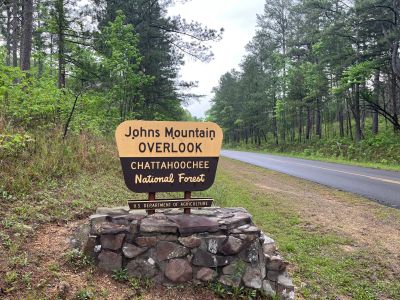 This Thursday we activated Johns Mountain WMA US-3758 from the Overlook site.

Allen KN4FKS set up his end fed half wave sloper antenna under the trees and Dan K2DTS warmed it up first. He made 20 contacts on 20 meters SSB. the band was wonky and contacts were either long or close. He had one in Alabama and one in California. Allen then used the same rig to make 21 contacts on 20 meters SSB with 7 P2P and 3 DX contacts which included a park to park in Bermuda before the rains came.

Danny AG4DW cranked up his rig using a vertical antenna and made 4 SSB contacts, 25 FT8 contacts and 2 FM contacts. With the two FM contacts on the 1.25 m band he accomplished a rather hard to get POTA award. The POTA N1CC award is obtained by making contacts on TEN bands in TEN different parks. He is the first of our crew to get this award, congratulations on all the hard work. John KB4QXI made 20 contacts on 20 meters with 16 P2P contacts and 2 Canadian DX contacts. 

The drive up the gravel road to the overlook is rough as usual but the mountain laurel bushes were in full bloom and made the trip a bit more bearable.

We seem to be in a springtime rain shower loop as every week we seem to be taking down antennas in the rain. Luckily none of the radio equipment has gotten wet. However antennas, coax and throw string need to be dried before the next activation. Hopefully the next activation will be a dry one. 

Again, congrats to Danny on the award. 
