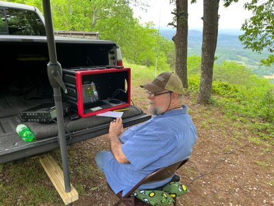This Thursday we activated Johns Mountain WMA US-3758 from the Overlook site.

Allen KN4FKS set up his end fed half wave sloper antenna under the trees and Dan K2DTS warmed it up first. He made 20 contacts on 20 meters SSB. the band was wonky and contacts were either long or close. He had one in Alabama and one in California. Allen then used the same rig to make 21 contacts on 20 meters SSB with 7 P2P and 3 DX contacts which included a park to park in Bermuda before the rains came.

Danny AG4DW cranked up his rig using a vertical antenna and made 4 SSB contacts, 25 FT8 contacts and 2 FM contacts. With the two FM contacts on the 1.25 m band he accomplished a rather hard to get POTA award. The POTA N1CC award is obtained by making contacts on TEN bands in TEN different parks. He is the first of our crew to get this award, congratulations on all the hard work. John KB4QXI made 20 contacts on 20 meters with 16 P2P contacts and 2 Canadian DX contacts. 

The drive up the gravel road to the overlook is rough as usual but the mountain laurel bushes were in full bloom and made the trip a bit more bearable.

We seem to be in a springtime rain shower loop as every week we seem to be taking down antennas in the rain. Luckily none of the radio equipment has gotten wet. However antennas, coax and throw string need to be dried before the next activation. Hopefully the next activation will be a dry one. 

Again, congrats to Danny on the award. 
