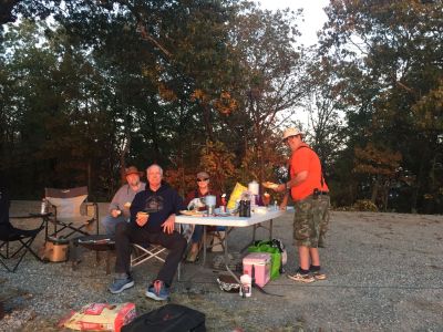 On late Monday afternoon (Oct 23, 2023) we gathered at the Johns Mountain WMA (K-3758) overlook to activate the park, cook a hotdog and watch the sunset. All three objectives were met. We set up three stations and played radio! Danny AG4DW made 43 SSB contacts with 3 P2P, 2 Alaska and one Venezuela mostly on 15 meters. John KB4QXI made 61 contacts with 9 P2P, 5 Canadian contacts plus one North Africa and one Venezuela mostly on 20 meters. Peter KX4BE made 20 contacts on CW with one FM contact for DX he had 2 Japan and one Chile. Allen KN4FKS had 12 contacts with 5 FM contacts on 70 cm. The other 7 were on 40 meters. 

As it got close to sundown at about 7 pm we took a break for supper and to watch the sunset from the overlook. We had hotdogs with the fixins cooked over charcoal, chips, macaroni salad, and smores for desert. There was supposed to be another desert cooked over the fire but someone (Karen KX4KM) forgot the essential ingredient, butter. We were assisted by our mascot dog I4ZZY. 

The sunset was spectacular and the company was the best. Thanks to all the hunters who make our fun possible. 

