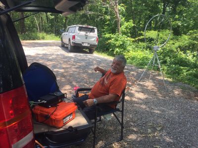 We activated Johns Mountain WMA US-3758 this Thursday from the overlook site on top of the mountain. The breeze kept up so the day didn't get too hot. Allen KN4FKS had 61 SSB contacts on 20 meters, 14 P2P and 6 DX with one P2P to the Dominican Republic and 5 Canadian stations. Ed KM6UTC had 58 digital  FT8 contacts with 9 DX contacts and three contacts in a row to Indonesia. John KB4QXI had 11 contacts with 1 P2P. Danny had 16 contacts on 2 meters, 70 cm, 20 Meters and 15 meters. He had a DX SSB contact with Saint Petersburg Russia. 

As usual at the overlook we had several visitors. First was the US Forest Service radio service technician checking on their repeater site 100 yards from the parking lot. They had erected a chain link fence around the tower and repeater house to hopefully slow down the copper thieves who steal the grounding wires from the tower legs and the radio equipment. Sad but true. We also had a Pinhoti Trail long distance hiker stop by and we helped him resupply his water bottles. ( He's in the background of one of the photos.) As we were getting ready to leave and elderly gentleman drove up and he was actually a HAM operator from the Villanow area. I didn't get his call sign but we had a nice chat. 

Then even the drive home was eventful. Danny's truck kept overheating and he had to stop and cool down several times to limp home. Probably a water pump issue. Allen got within a mile of home and Winston just sputtered and quit running. It wasn't the heat it simply is not getting spark for some reason. Karen came and towed Winston home. Sort that out later when it cools off a bit. I hope Ed and John made it home without incident there seems to be a trend starting here. I hope not. 
