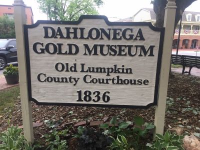 5-25-2022, I activated the Dahlonega Gold Museum K-7456. To set up radios I set my vertical antenna in the grass half way between the building and the street. The radio and tuner were placed on a low brick wall and that was my operating position. Got on the air on 20 meters and had a noise floor of S-7 to 8. Made 13 contacts with 1 P2P and 2 DX (Spain, Canada) before I had to go QRT because it was about to rain. With all the passers by and tourist I spent a fair bit of time explaining what I was doing.
